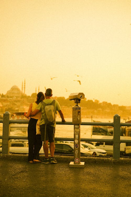 Couple Standing and Looking at the View of City and Sea 