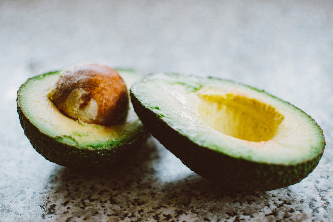 Selective Focus Photography Of Sliced Avocado