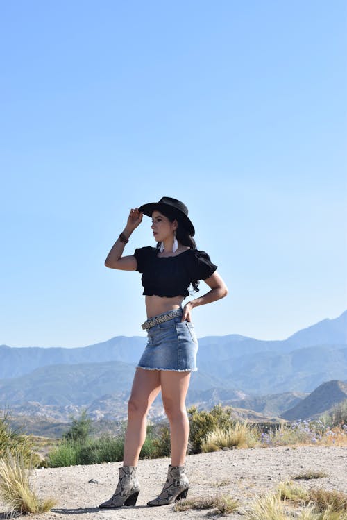 Woman in a Black Hat and Cowboy Boots 