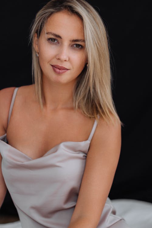 Blonde Woman Posing in Grey Cowl Neck Strap Dress