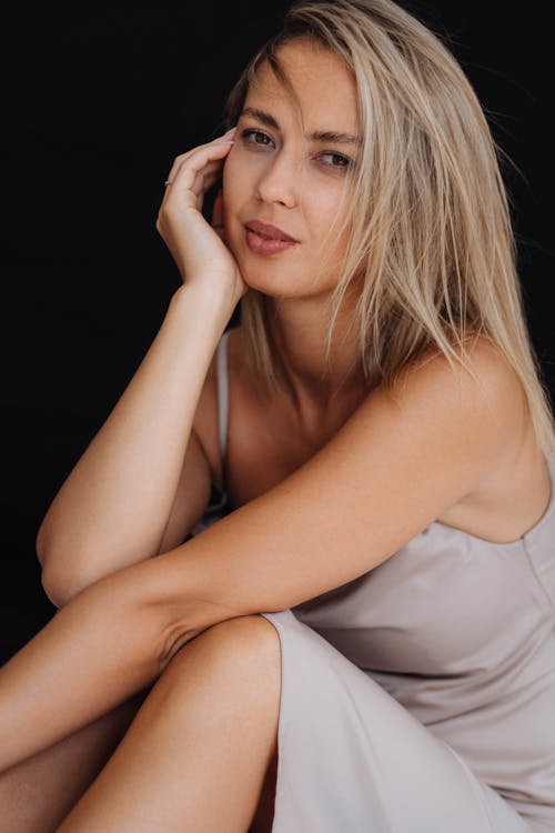 A Model in a Beige Nightie on the Black Background