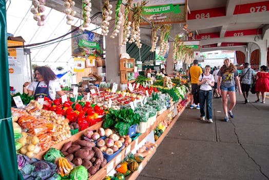 Colorful farmers market scene with a variety of fresh vegetables and shoppers exploring the stalls.