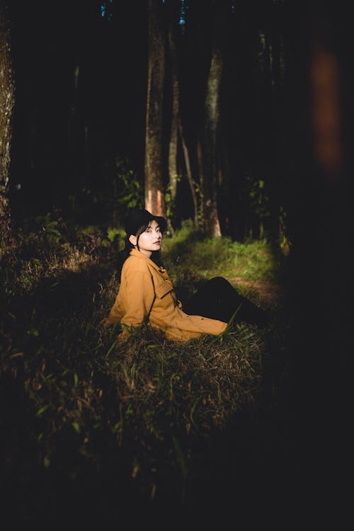Woman Sitting and Posing in Forest