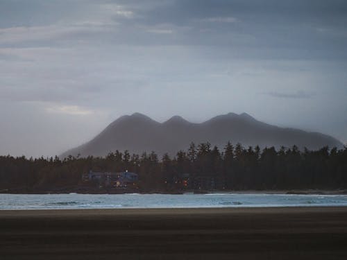 Free Lake and Woods Against Mountains on Horizon Stock Photo