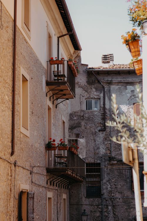 Free Elegant balconies with potted flowers in a historic urban residential area. Stock Photo