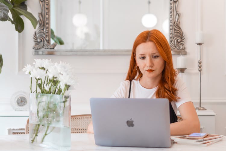 Woman Working On Laptop On Desk