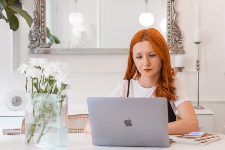 Young Woman Using Laptop At Desk