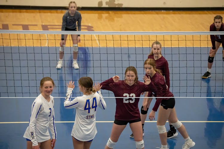 Young Girls Playing In A Volleyball Match 