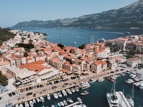 Free Aerial view of the coastal town Korčula, Croatia, showcasing its marina and vibrant architecture. Stock Photo