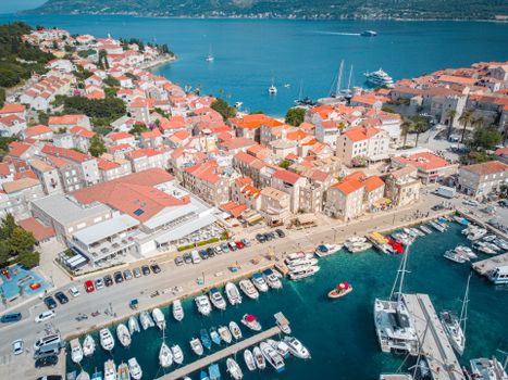 A stunning aerial view of Korcula's old town and marina with vibrant blue sea.