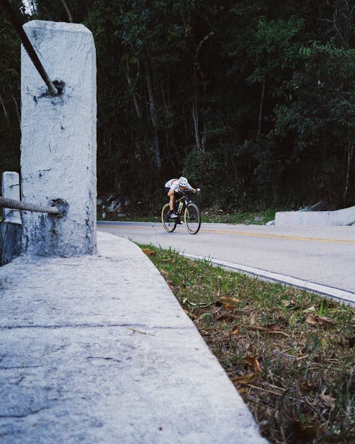 Man Riding Downhill on a Bicycle