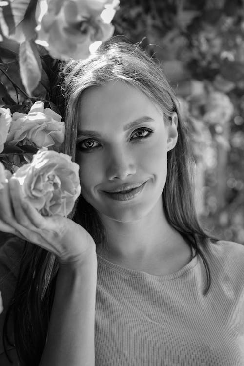 Smiling Woman with Flower in Black and White