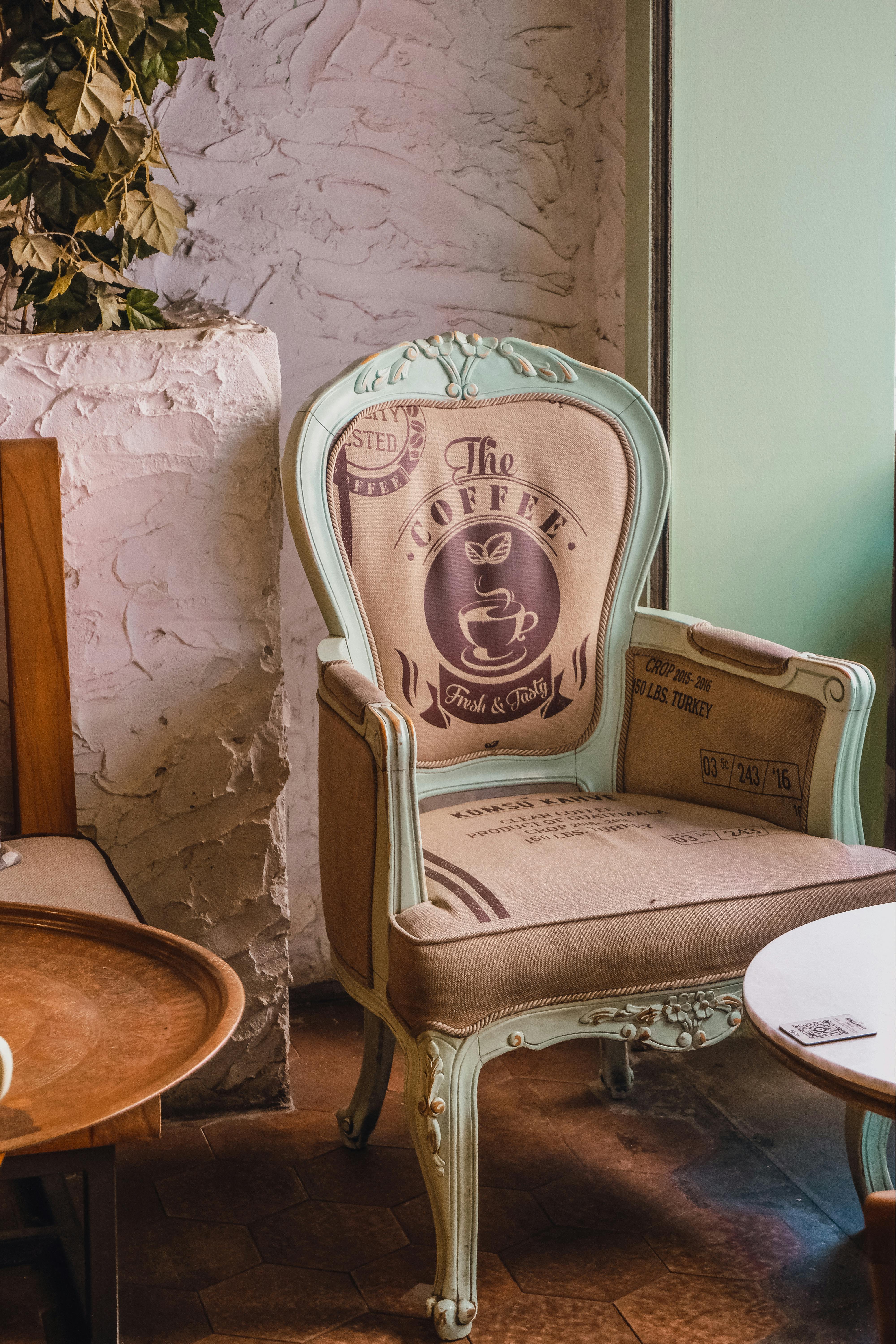 Elegant vintage chair with coffee design in a cozy cafe corner, showcasing unique decor and style.