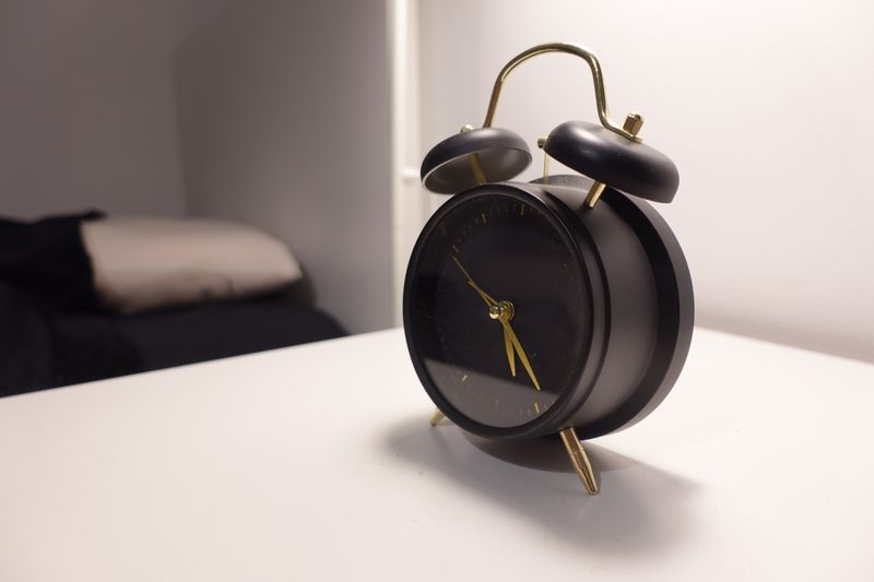 alarm clock on a nightstand in a dark room