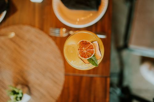 Free Top view of a refreshing citrus cocktail with mint garnish on a wooden table. Stock Photo