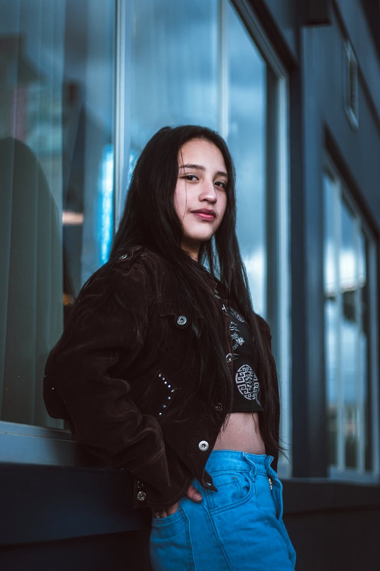 Photo Of A Teenage Girl Posing By A Window