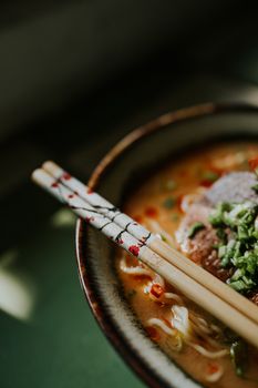 A mouthwatering shot of gourmet ramen served with beef and vegetables in a ceramic bowl.
