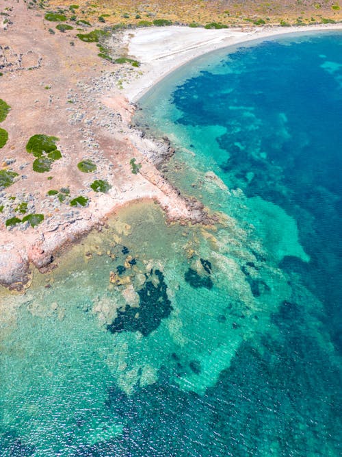 Aerial Footage of a Sandy Coast and a Turquoise Sea