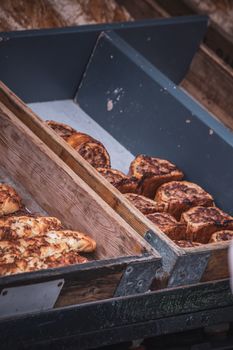 Artisan breads displayed in rustic wooden containers, showcasing fresh sourdough and pastries.