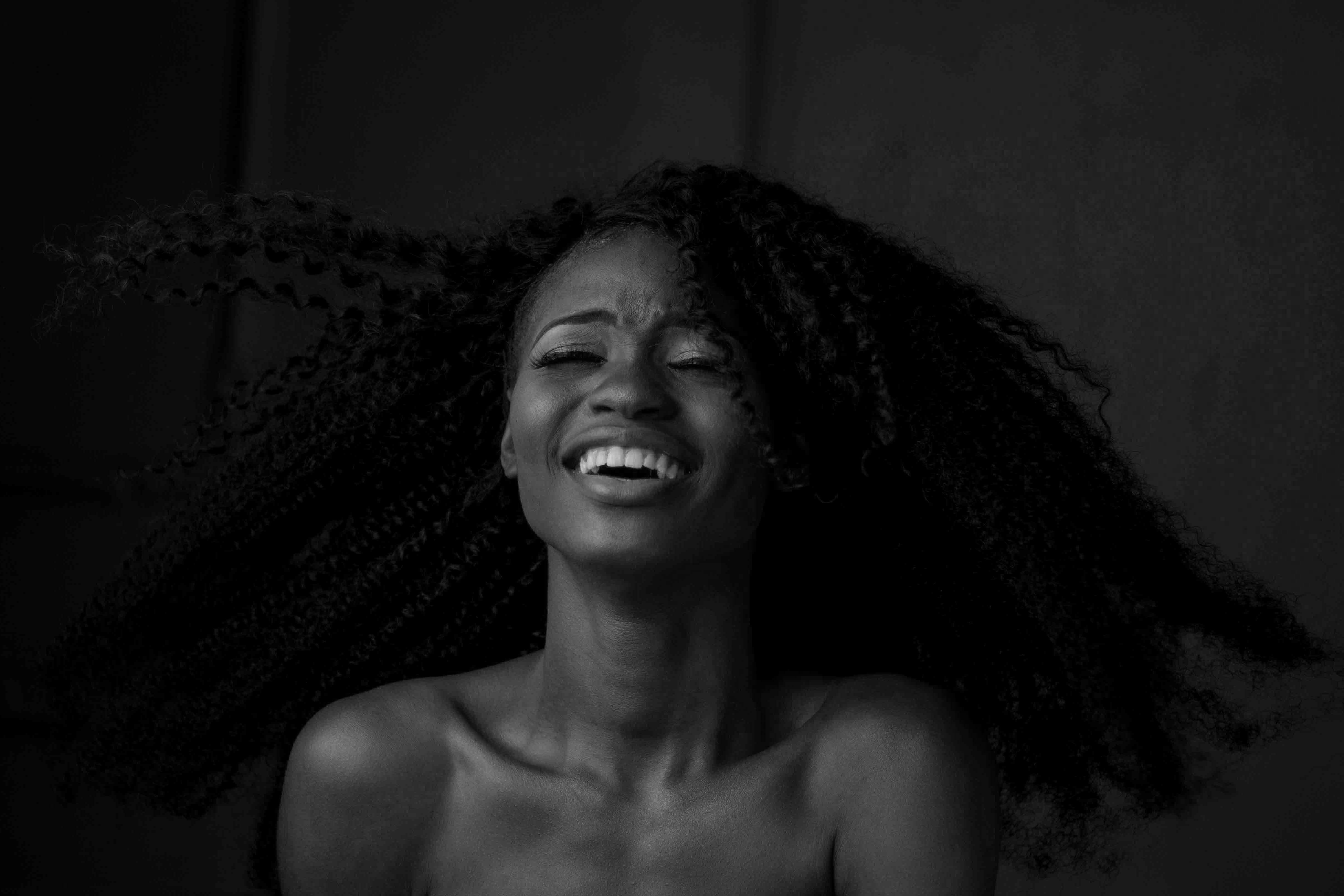 grayscale photography of smiling woman