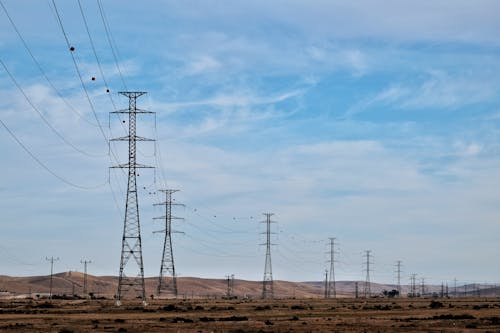 Utility Poles and Electricity Lines on a Desert 