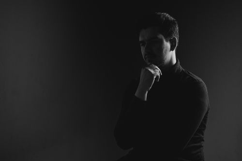 Free Stylish black and white studio portrait of a man in thoughtful pose. Stock Photo