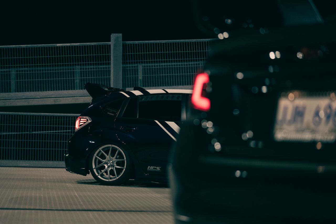 dramatic image of sports cars parked at night featuring sleek designs