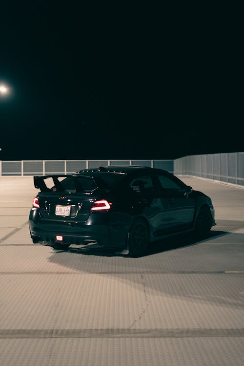 A Black Subaru WRX on the Parking Lot at Night 