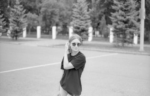 Black and White Picture of a Young Woman Standing Outside 