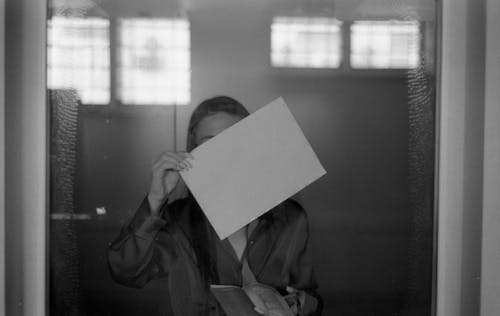 Woman Holding Blank Paper Sheet