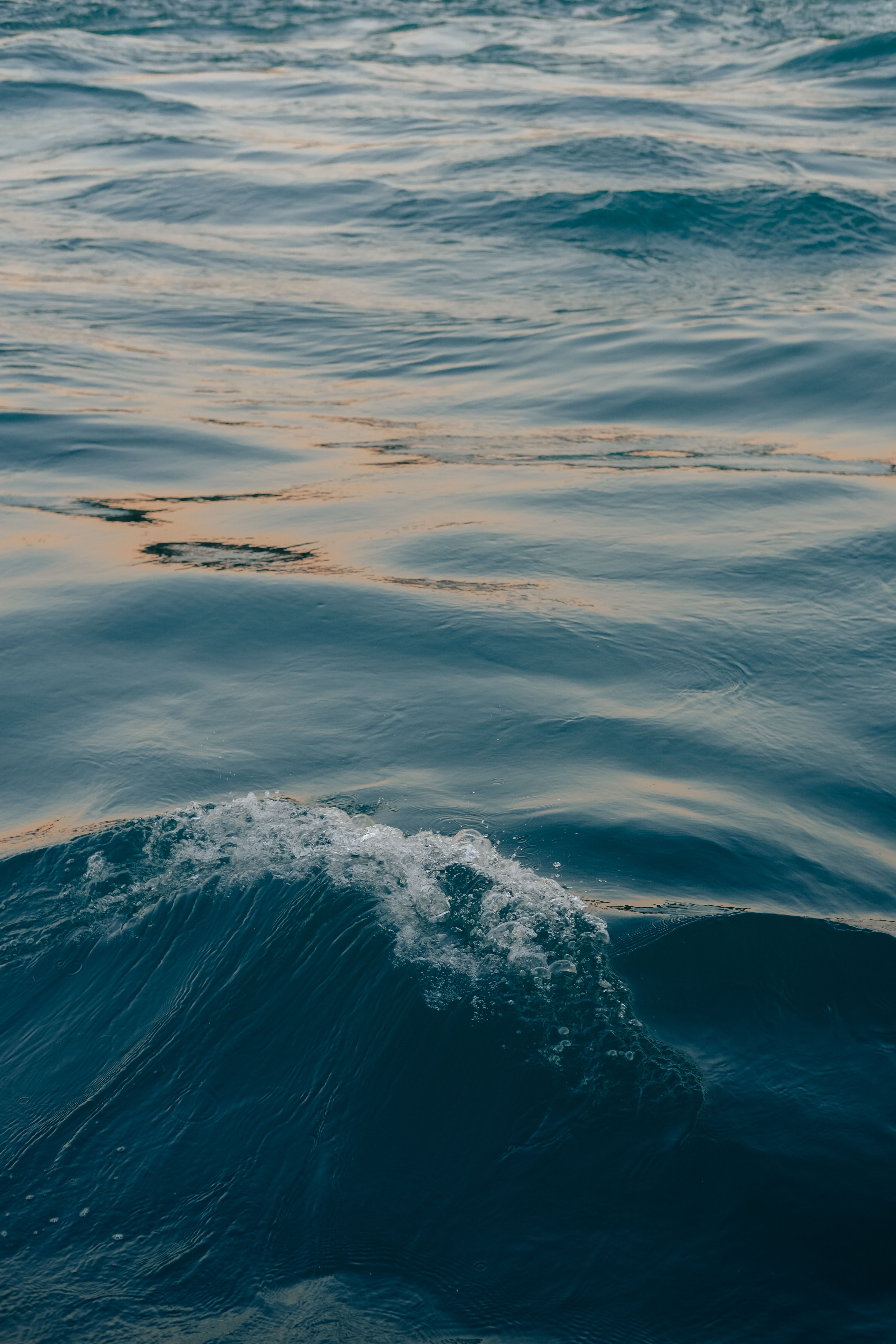 A calming view of ocean waves during sunset, capturing the serene beauty of nature.