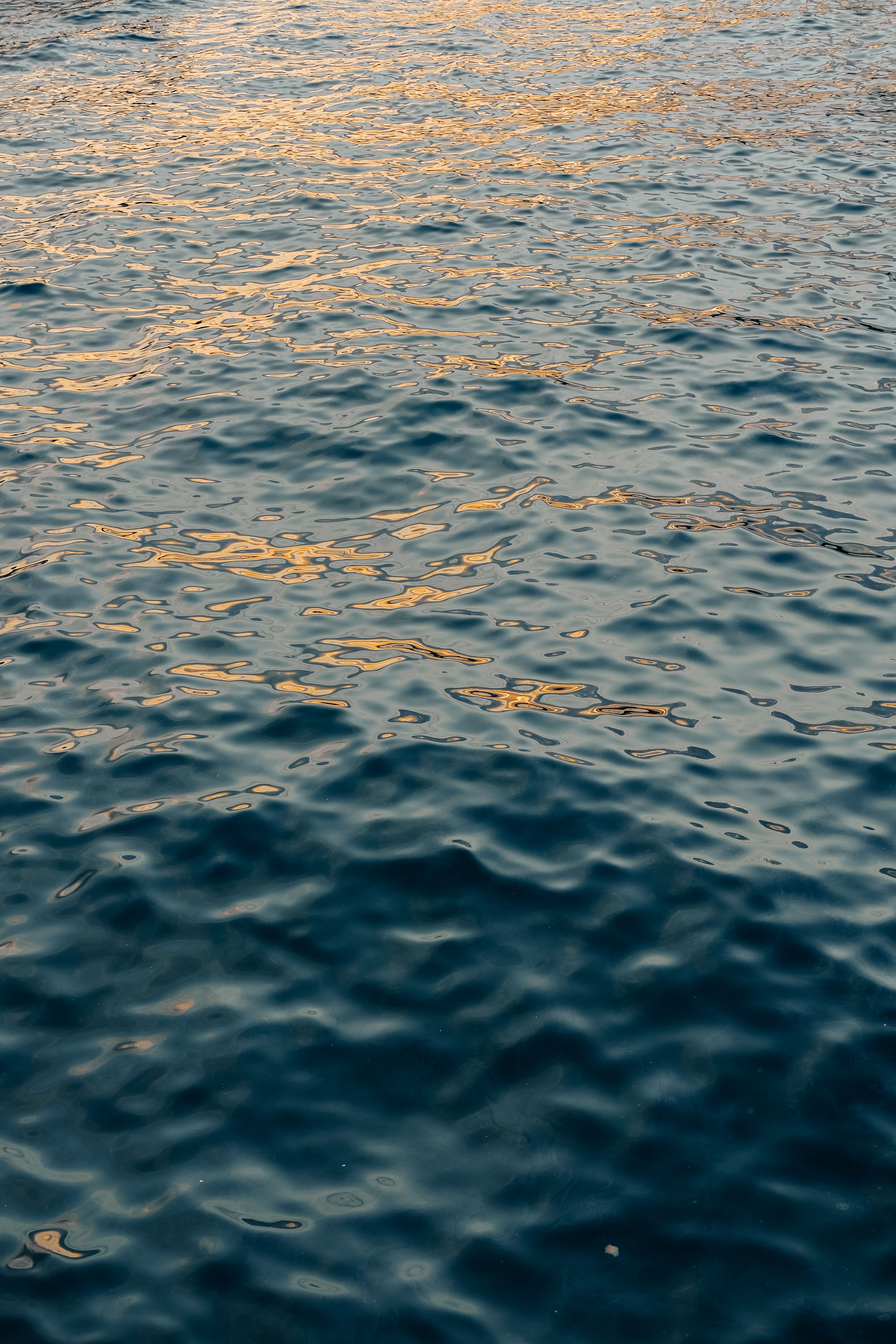 Close-up of Water Surface with Reflection of the Sunset · Free Stock Photo
