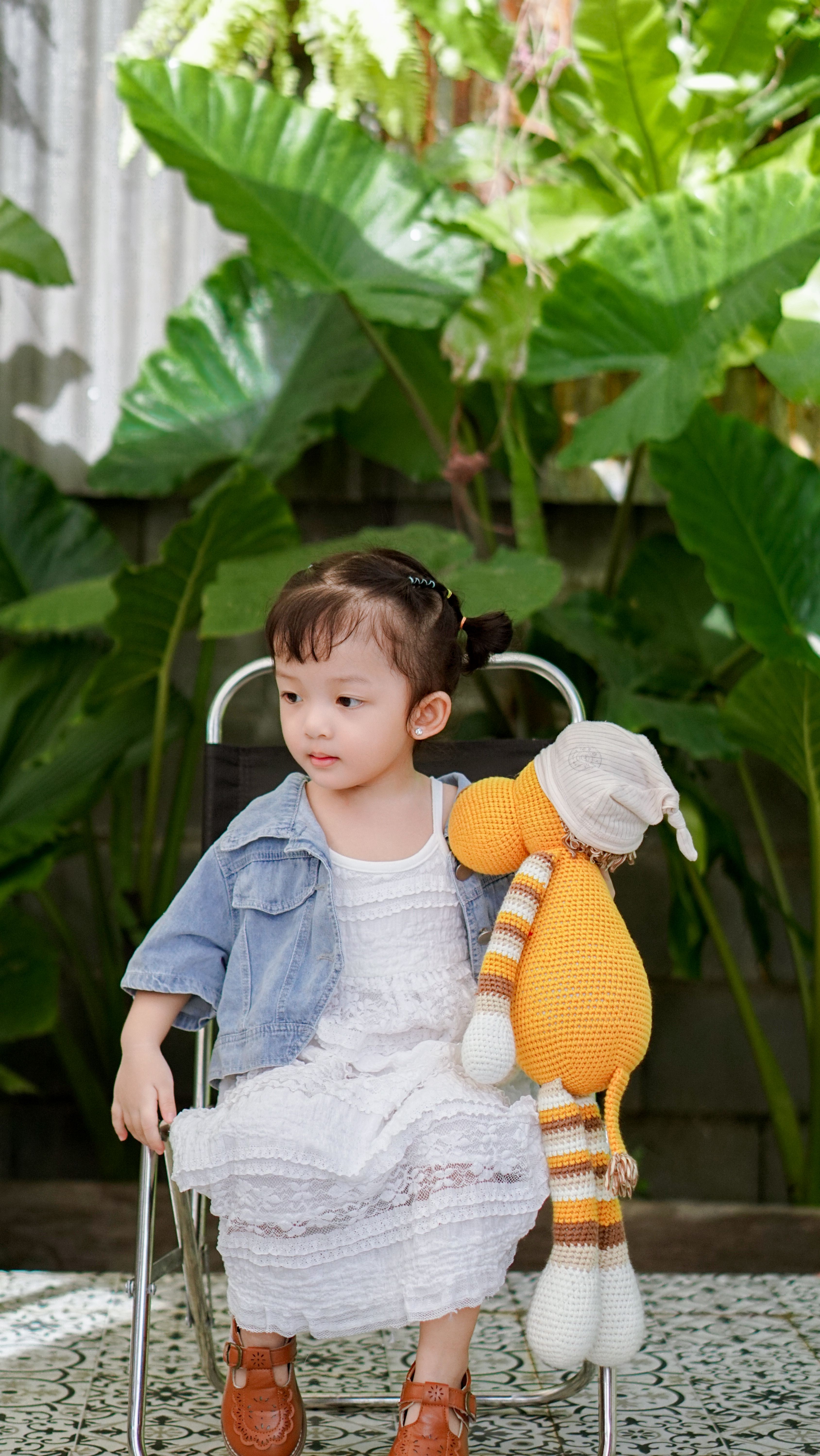 Baby Wearing White Headband and White Lace Floral Dress Sitting Beside