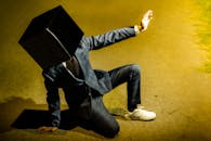 Model in Suit and with Cardboard Box on Head