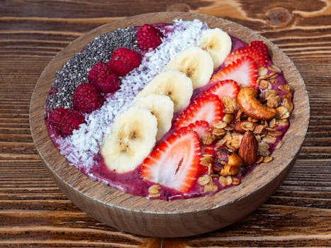 Colorful smoothie bowl topped with bananas, strawberries, and chia seeds for a healthy breakfast.