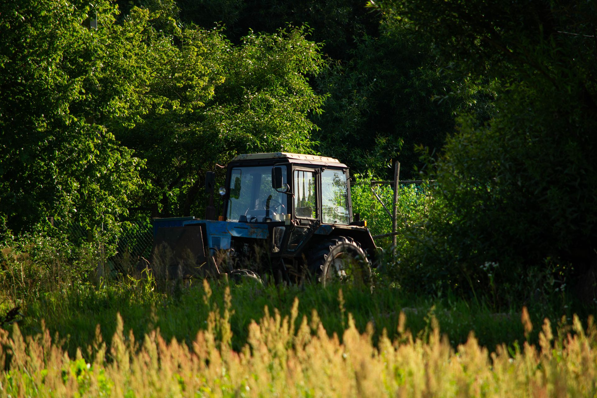 A Tractor Parked on a Grass Field