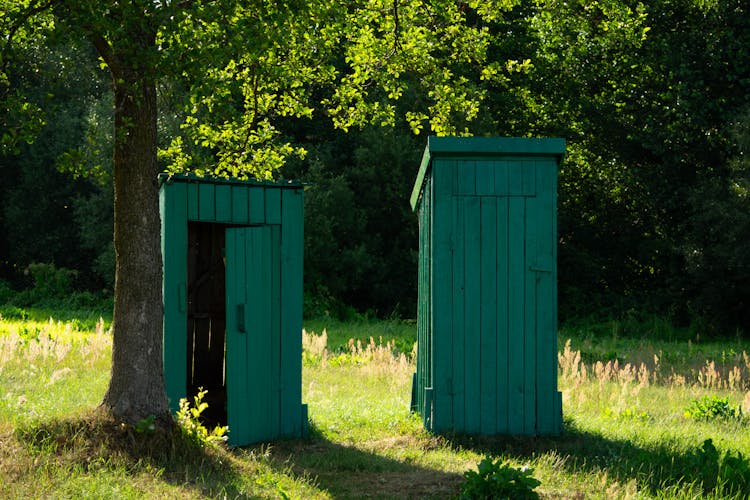 Small Wooden Huts On The Field 