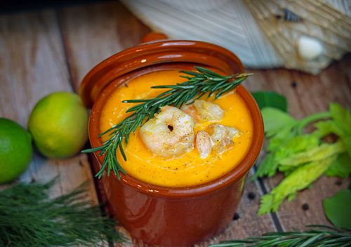 Free Close-up of a hearty shrimp soup garnished with rosemary and fresh herbs. Stock Photo