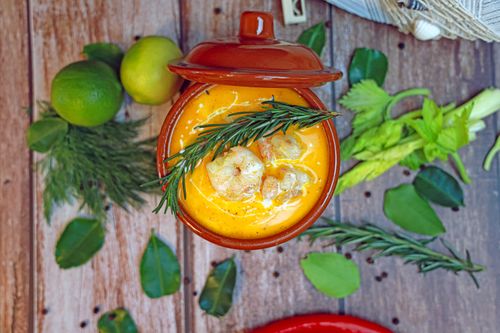 Free Delicious shrimp soup with fresh herbs and citrus, perfect for a gourmet meal. Stock Photo