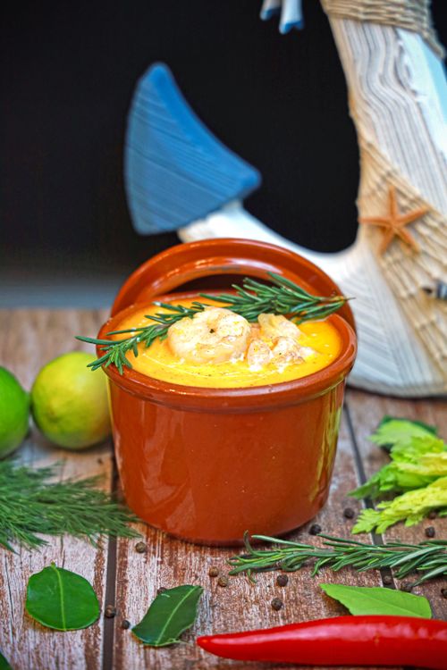 Free Savor a vibrant seafood soup topped with herbs, perfect for food lovers. Stock Photo