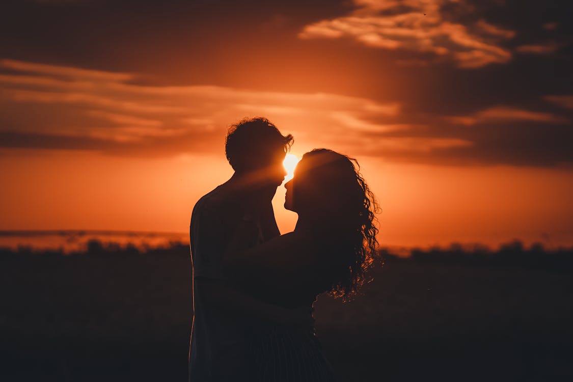 Silhouetted lovers at sunset
