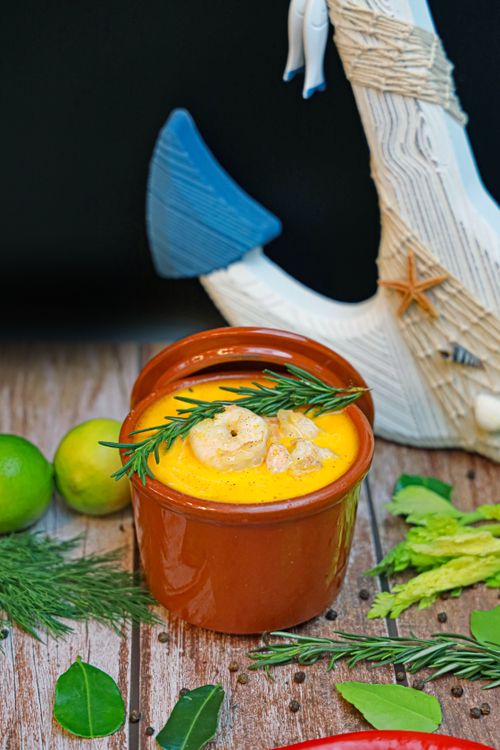 Free Delicious shrimp bisque garnished with herbs and citrus for a fresh taste. Stock Photo