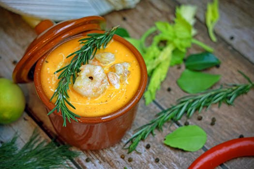 Delicious shrimp bisque garnished with herbs, perfect for a cozy meal.
