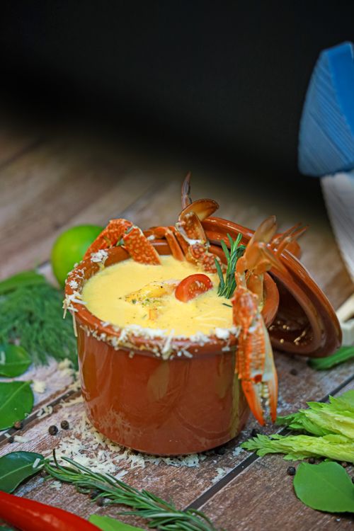 Free Delicious seafood crab dip served in a rustic pot with fresh herbs and spices. Stock Photo