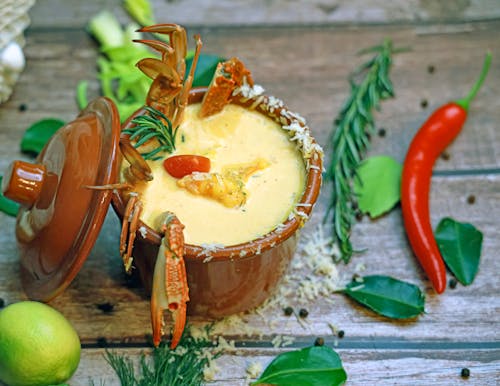 A bowl of soup with crab and other ingredients