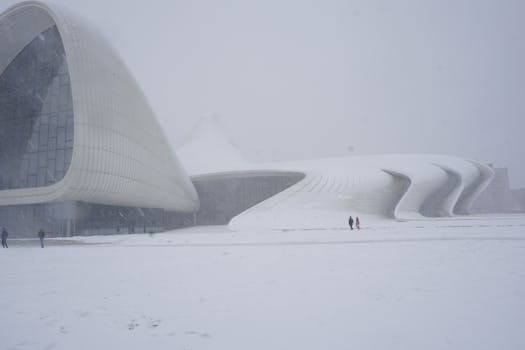 The Heydar Aliyev Center in Baku covered in snow, showcasing modern architecture in winter.