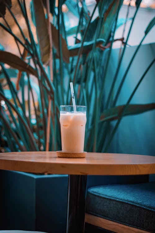 A Glass of Iced Coffee Standing on a Table in a Cafe 
