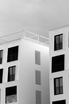 Contemporary apartment buildings in Wrocław, showcasing modern architecture in black and white.