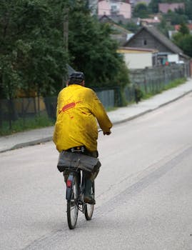 Man biking on a quiet suburban street, showcasing urban living and outdoor recreation.