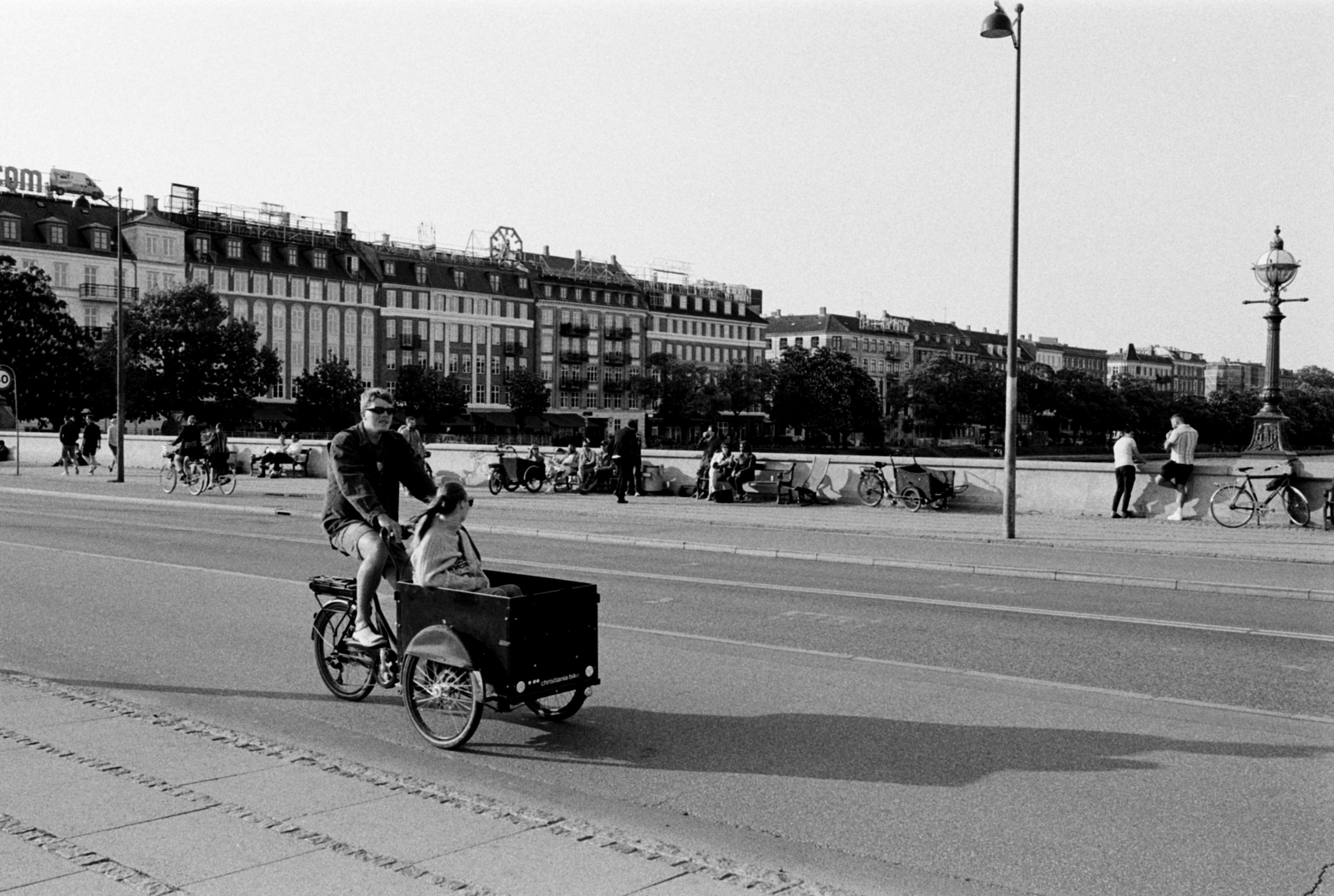 Black and white scene of a cyclist in Copenhagen street.